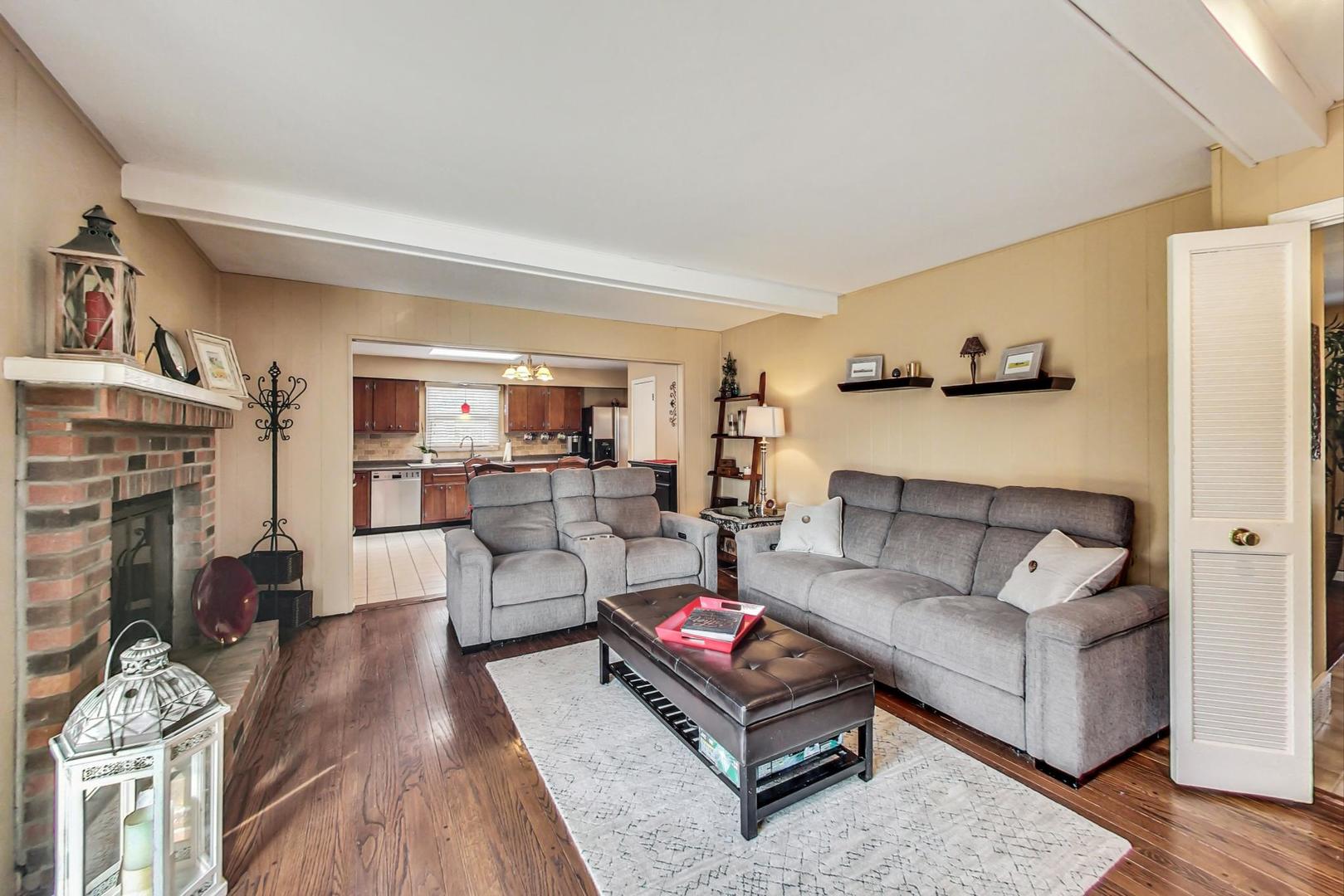 6S271 New Castle Road Naperville, IL 60540 - Photo 8 of 34 a living room with furniture and a fireplace