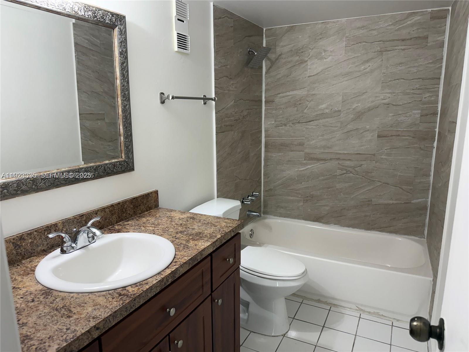 14250 Southwest 62nd Street, Unit 524 Miami, FL 33183 - Photo 13 of 27 a bathroom with a sink a toilet and shower