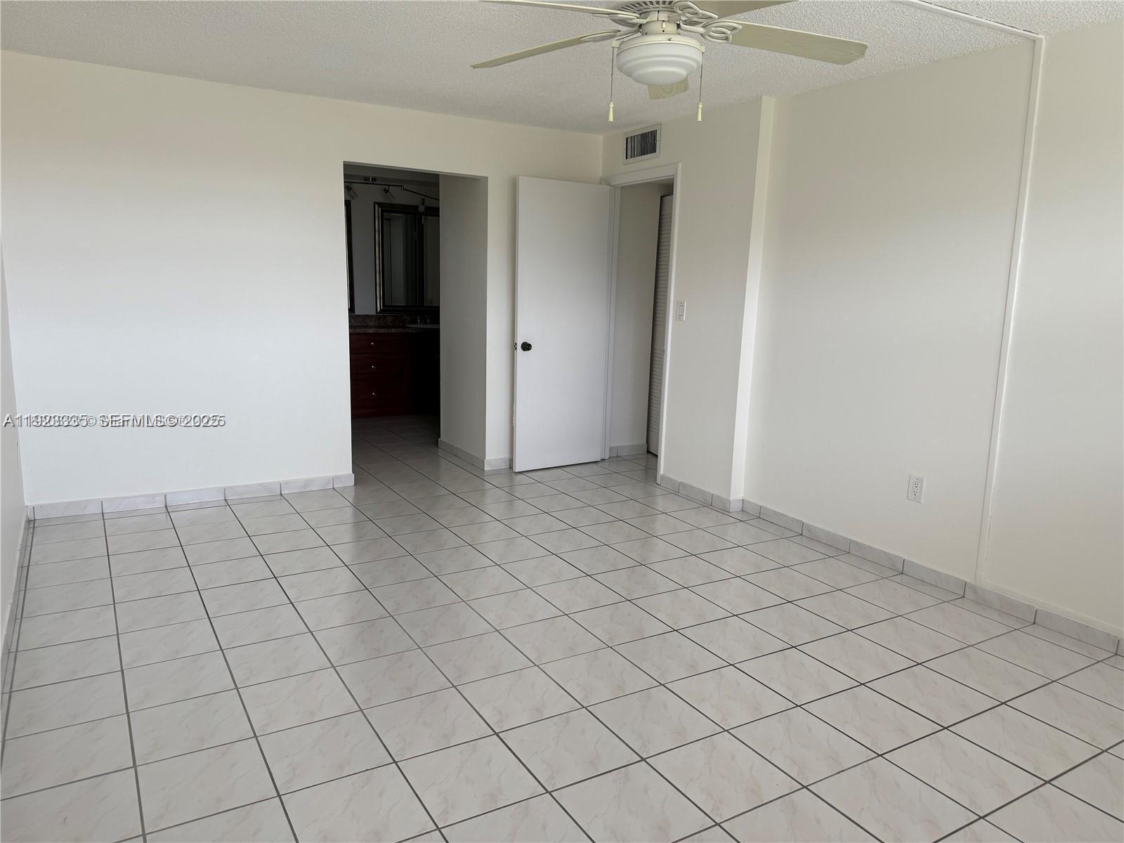 14250 Southwest 62nd Street, Unit 524 Miami, FL 33183 - Photo 16 of 27 an empty room with a ceiling fan