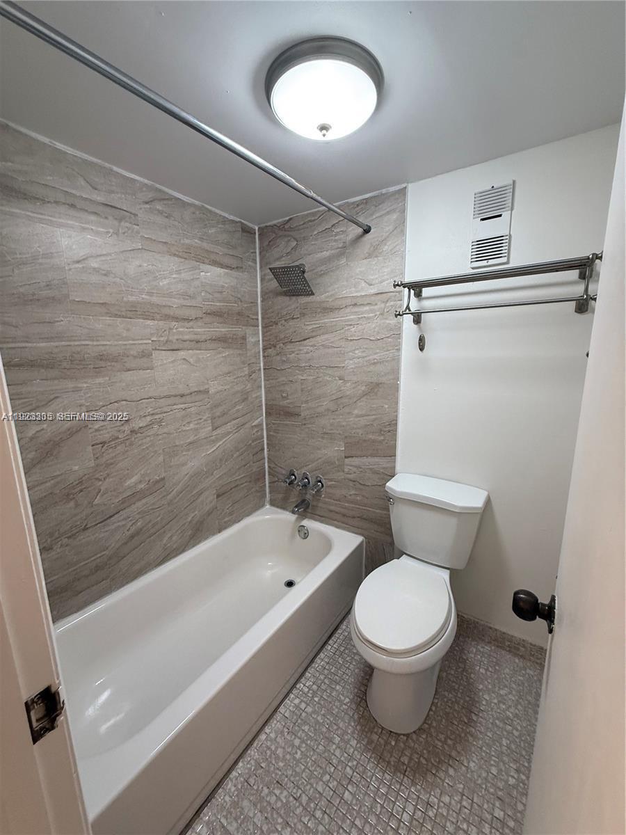 14250 Southwest 62nd Street, Unit 524 Miami, FL 33183 - Photo 20 of 27 a bathroom with a toilet and a shower