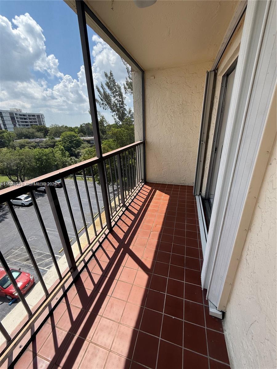 14250 Southwest 62nd Street, Unit 524 Miami, FL 33183 - Photo 24 of 27 a view balcony with wooden floor