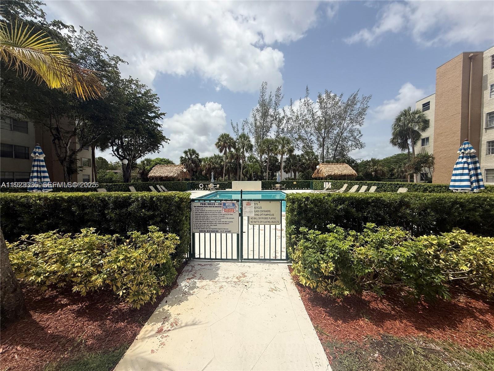 14250 Southwest 62nd Street, Unit 524 Miami, FL 33183 - Photo 27 of 27 a garden view with iron fence