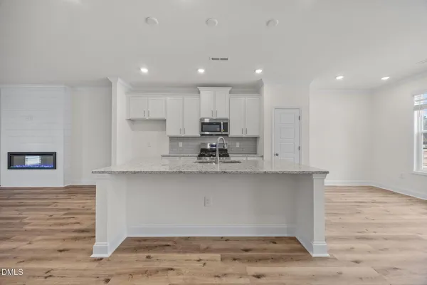 a kitchen with stainless steel appliances granite countertop lots of counter space sink and cabinets