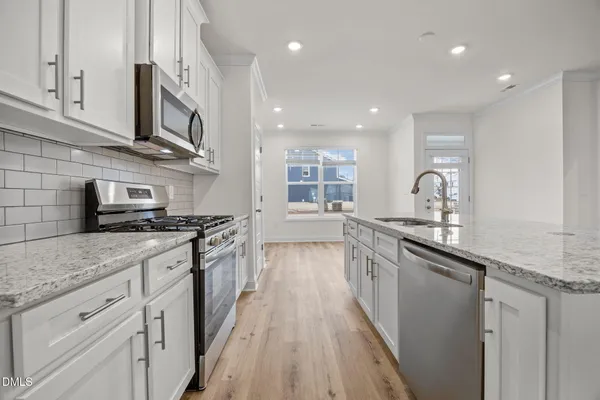 a stove top oven sitting inside of a kitchen