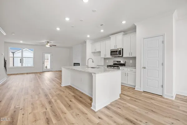 a view of a kitchen with a sink and cabinets