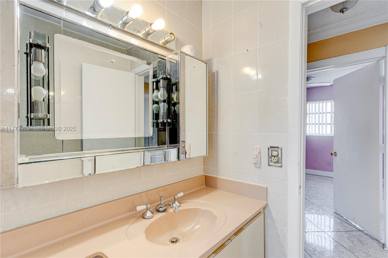 390 East 44th Street Hialeah, FL 33013 - Photo 18 of 39 a bathroom with a sink and a mirror