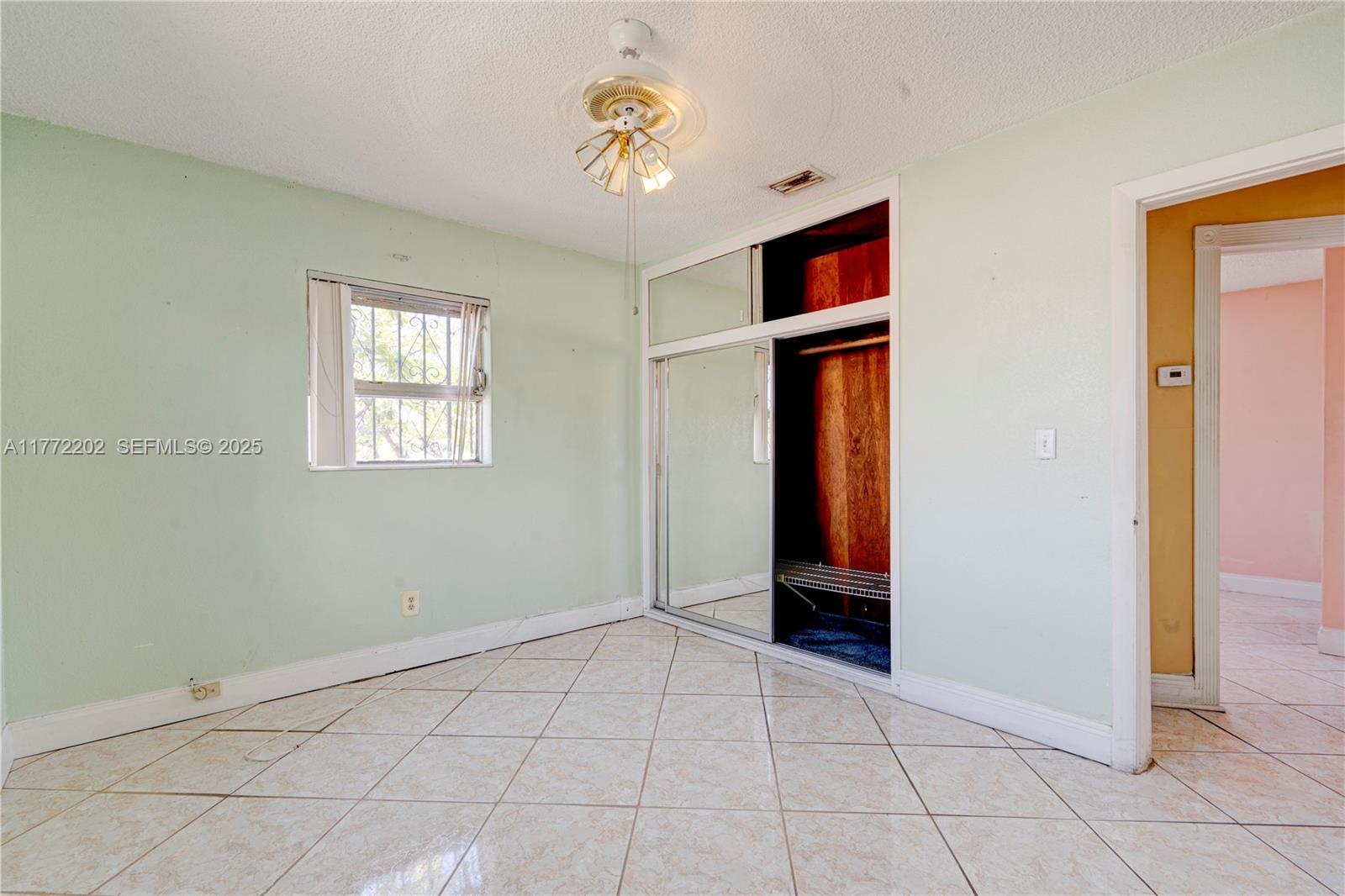 390 East 44th Street Hialeah, FL 33013 - Photo 19 of 39 an empty room with closet and windows