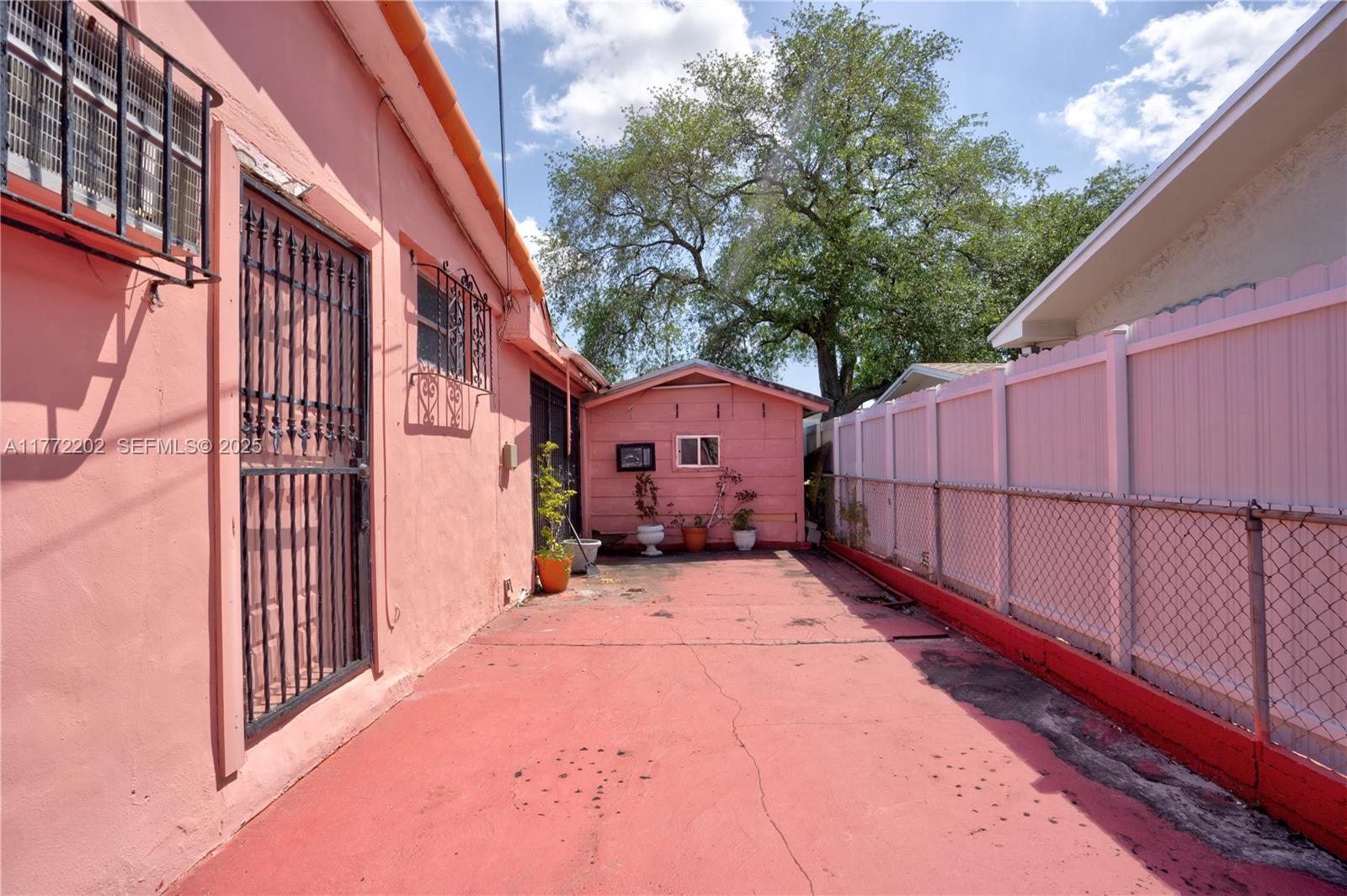 390 East 44th Street Hialeah, FL 33013 - Photo 30 of 39 a view of a house with a wooden fence