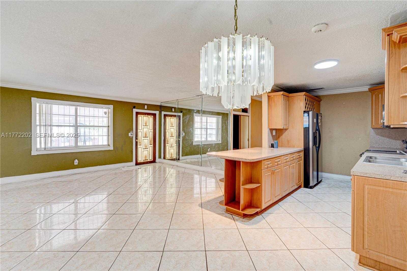 390 East 44th Street Hialeah, FL 33013 - Photo 4 of 39 a large spacious bathroom with mirror and a chandelier