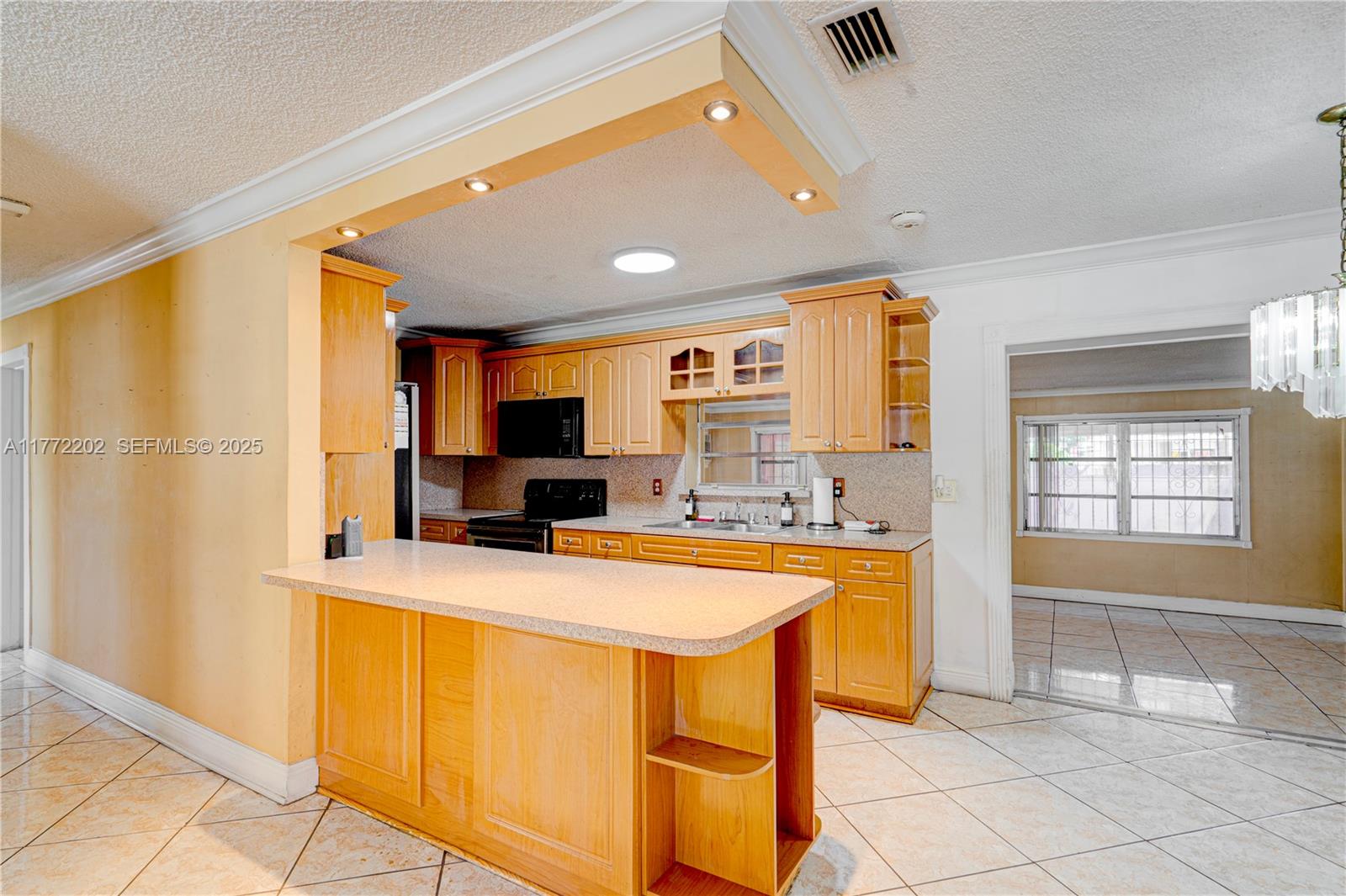 390 East 44th Street Hialeah, FL 33013 - Photo 9 of 39 a kitchen with stainless steel appliances granite countertop a sink a stove and refrigerator
