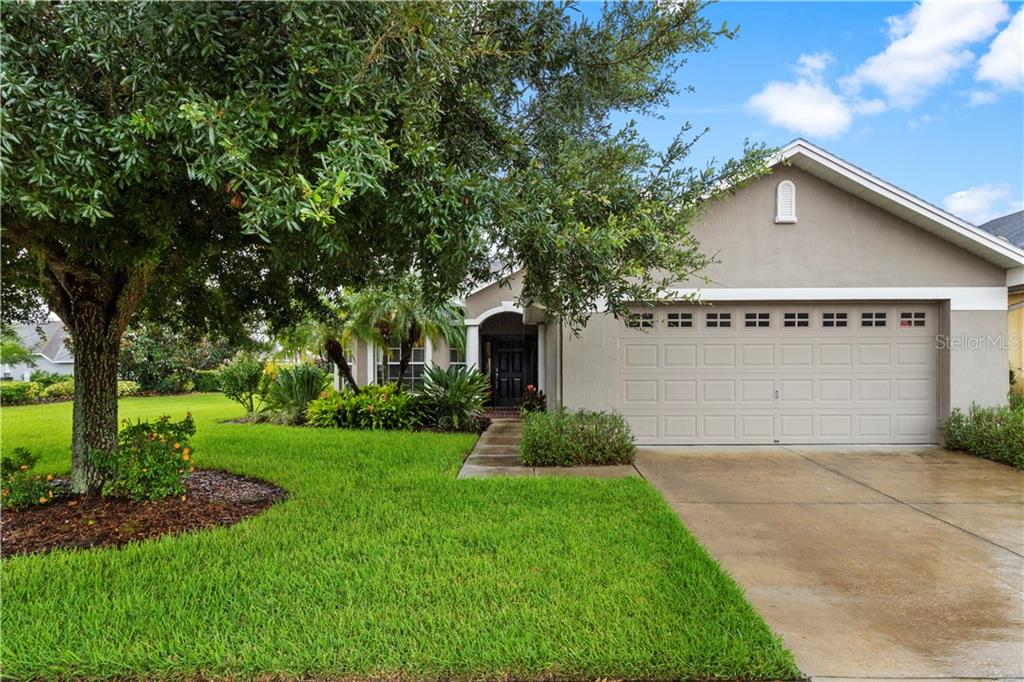 6810 Eagle Ridge Loop Lakeland, FL 33813 - Photo 1 of 1 a front view of house with yard and green space