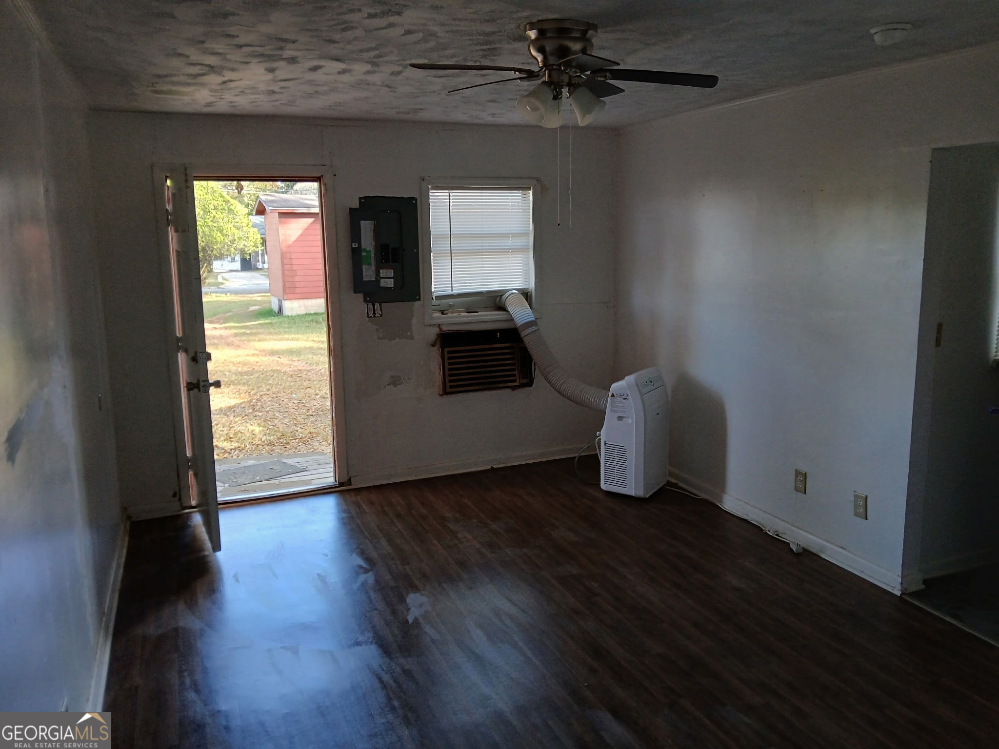 218 A Hunt Street Fort Valley, GA 31030 - Photo 8 of 8 wooden floor in an empty room with a window