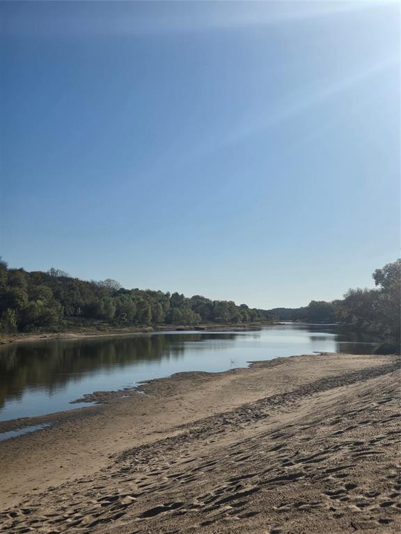 1021 Riverview Road Millsap, TX 76066 - Photo 13 of 26 Water view featuring a heavily wooded area