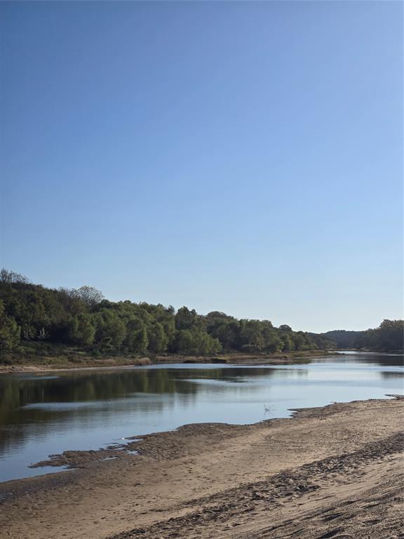 1021 Riverview Road Millsap, TX 76066 - Photo 15 of 26 Water view with a heavily wooded area