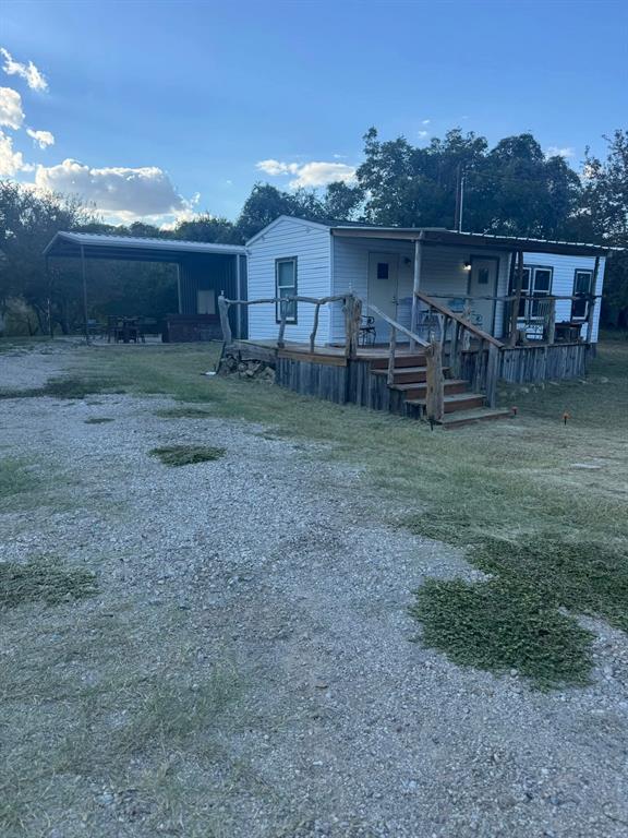 1021 Riverview Road Millsap, TX 76066 - Photo 7 of 26 View of front of house featuring a carport and a front yard