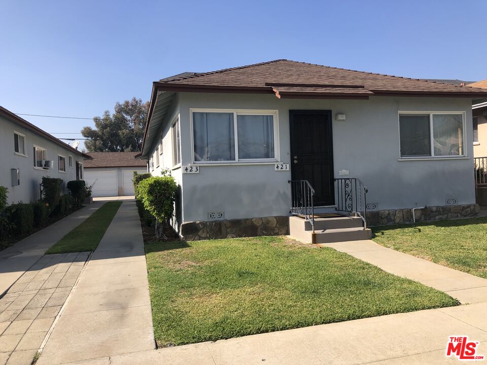 417 North 7th Street Montebello, CA 90640 - Photo 3 of 6 a front view of a house with a yard