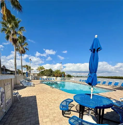 a swimming pool with outdoor seating and yard
