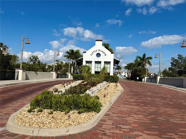a view of a white house with a yard patio and fire pit