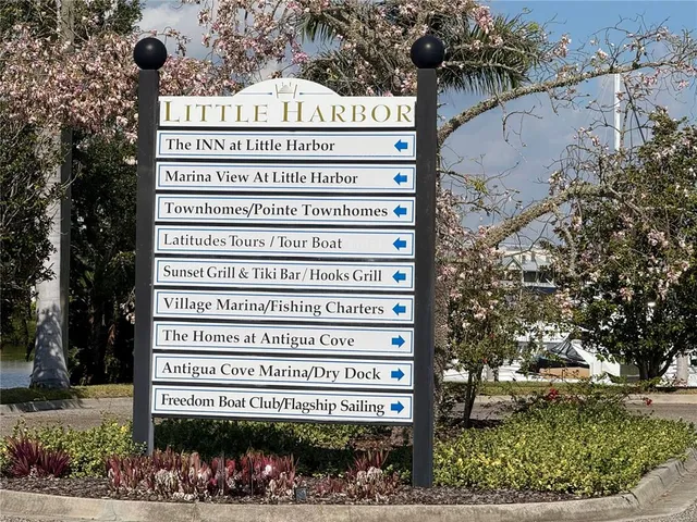 a view of a sign board with a yard