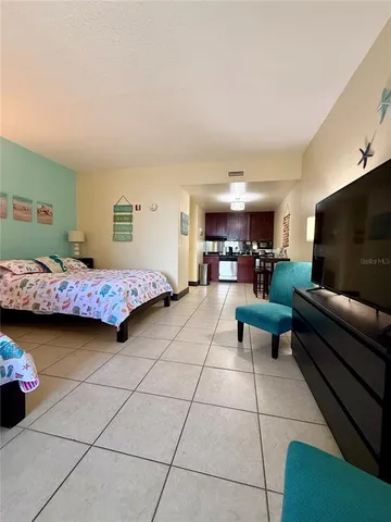 a bedroom with furniture and a flat screen tv