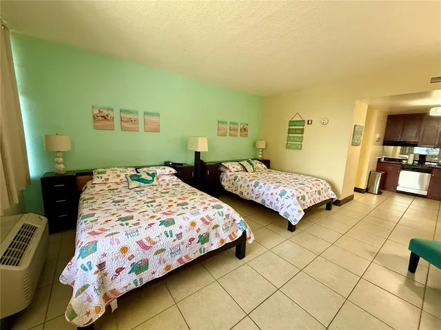 a bedroom with two beds and painting on the wall