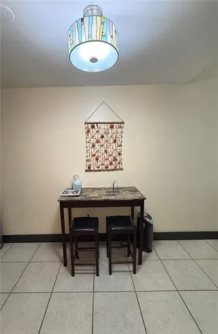 a view of a room with a table and chairs