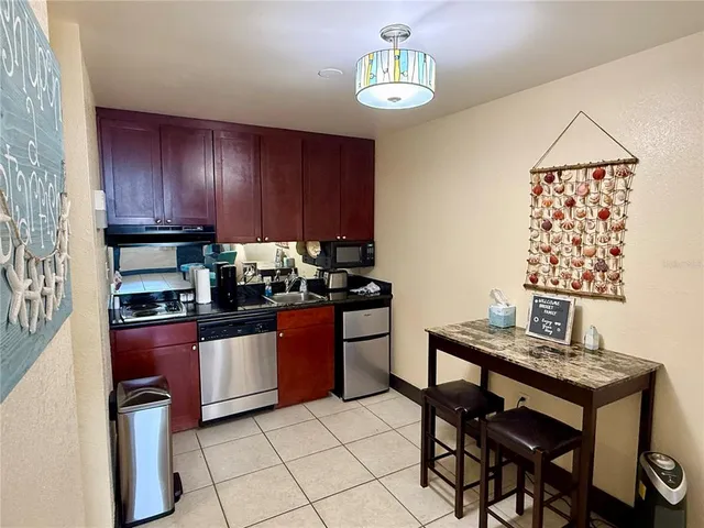 a kitchen with granite countertop wooden cabinets and stainless steel appliances