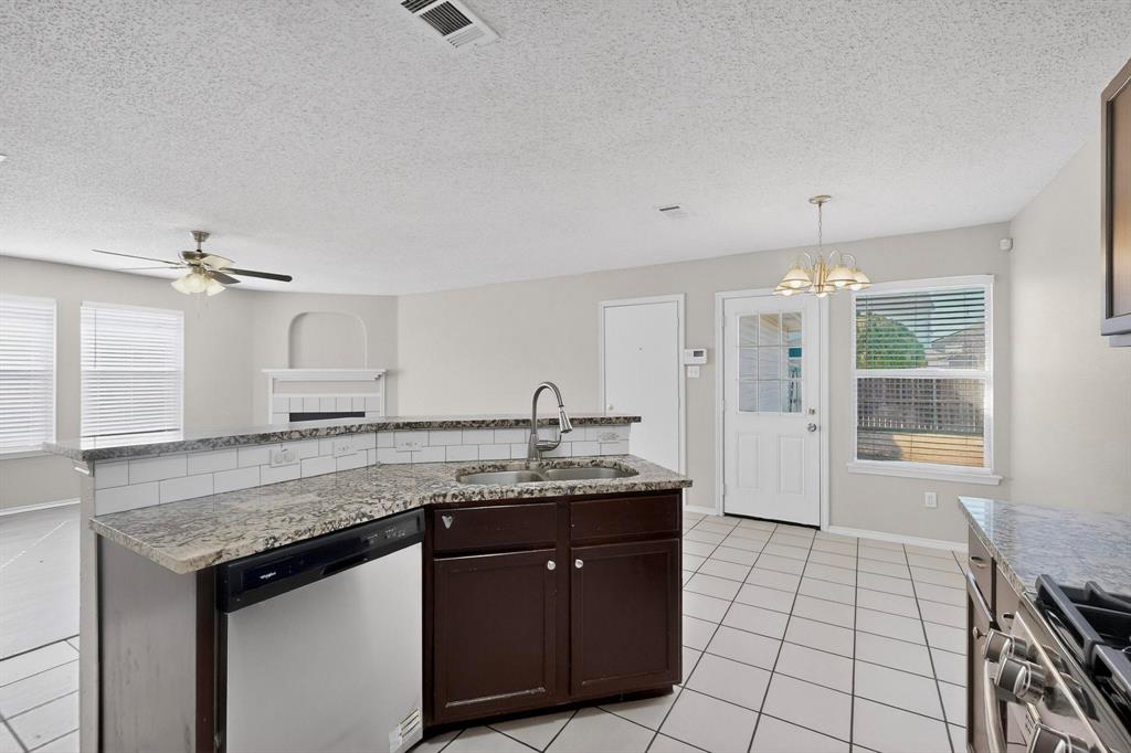 1207 Aberdeen Drive Allen, TX 75002 - Photo 13 of 40 a kitchen with a sink a counter space cabinets and appliances