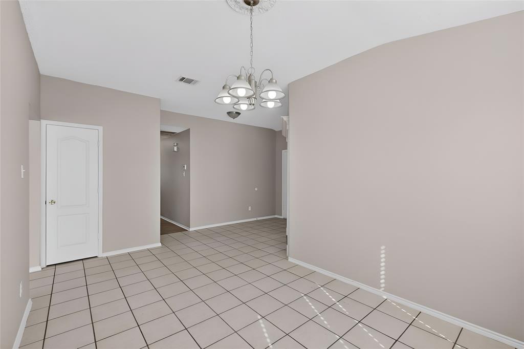 1207 Aberdeen Drive Allen, TX 75002 - Photo 16 of 40 a view of an empty room with chandelier