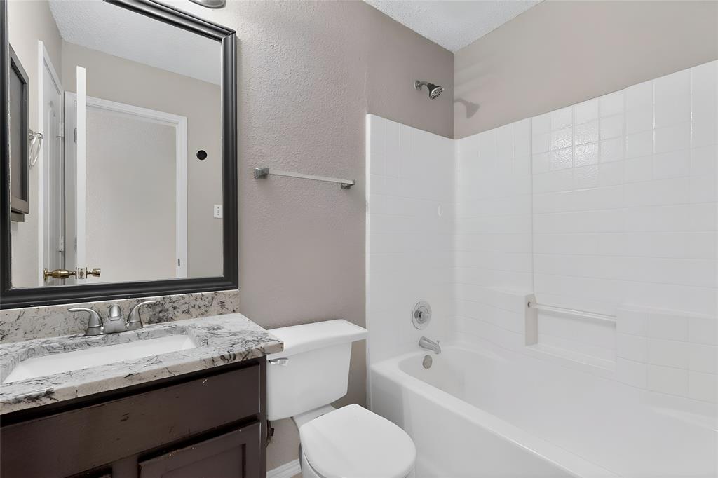 1207 Aberdeen Drive Allen, TX 75002 - Photo 20 of 40 a bathroom with a granite countertop sink toilet and shower