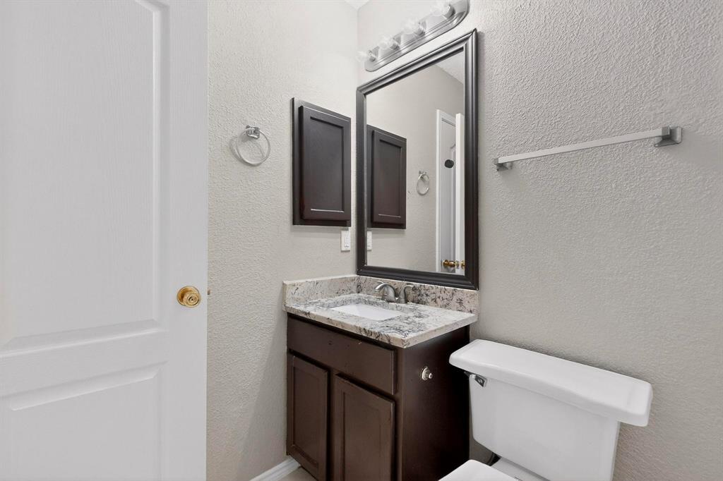 1207 Aberdeen Drive Allen, TX 75002 - Photo 21 of 40 a bathroom with a sink toilet and mirror