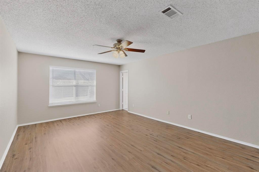 1207 Aberdeen Drive Allen, TX 75002 - Photo 22 of 40 wooden floor in an empty room with a window