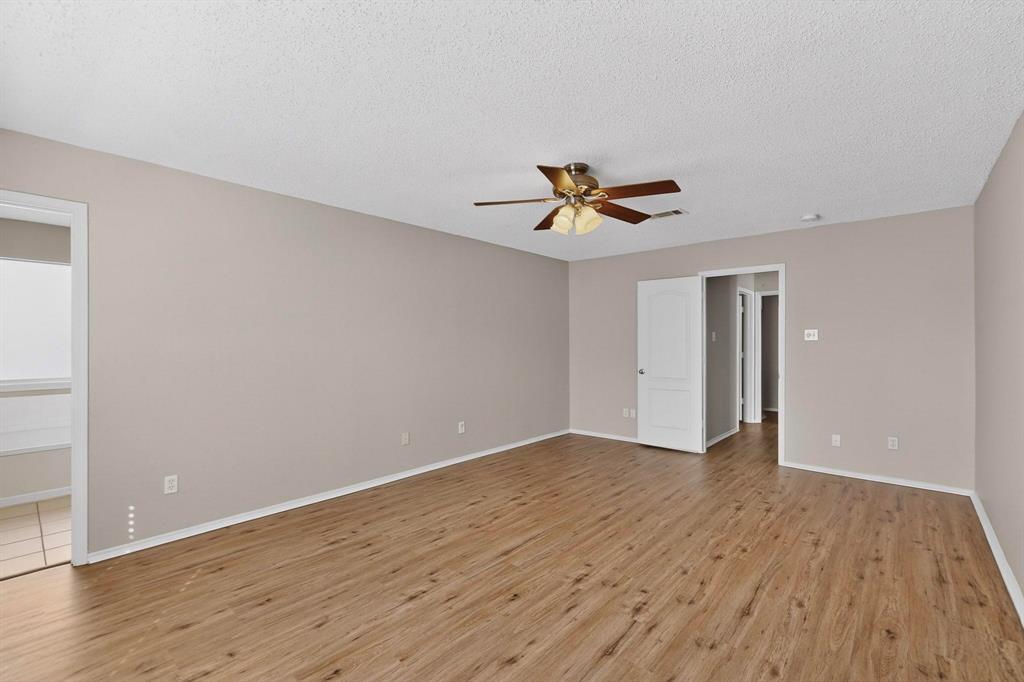 1207 Aberdeen Drive Allen, TX 75002 - Photo 25 of 40 a view of an empty room with wooden floor and a window