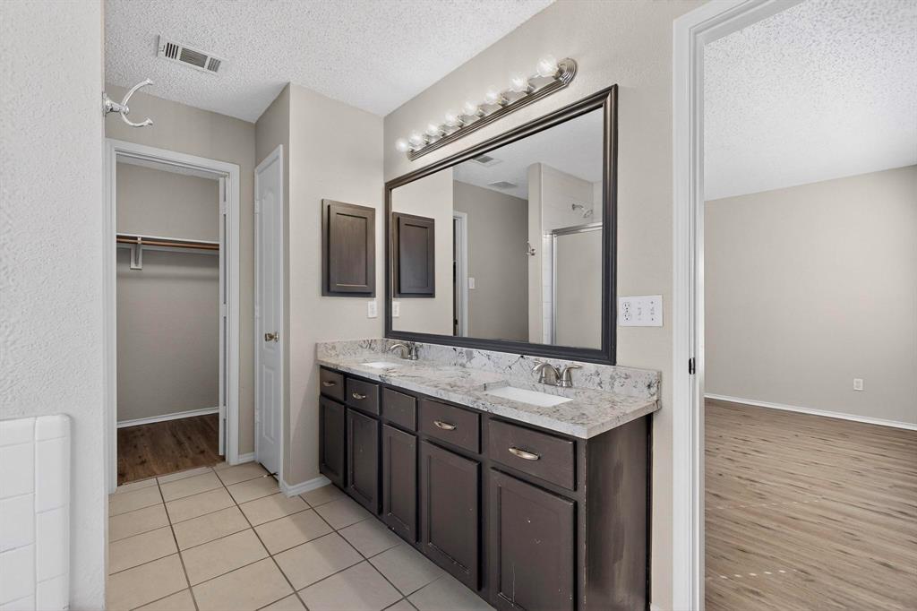 1207 Aberdeen Drive Allen, TX 75002 - Photo 26 of 40 a bathroom with a sink vanity and mirror