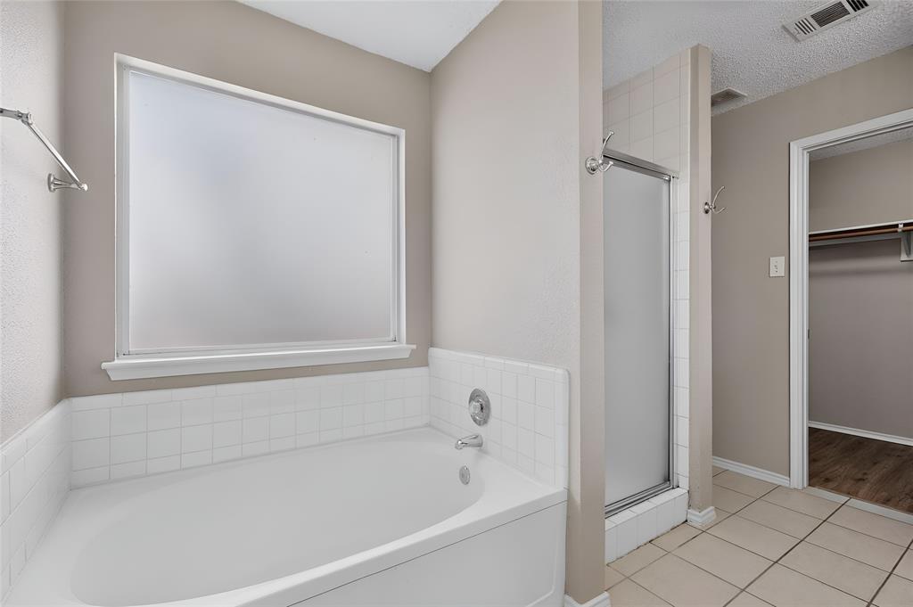 1207 Aberdeen Drive Allen, TX 75002 - Photo 28 of 40 a white bath tub sitting next to a shower