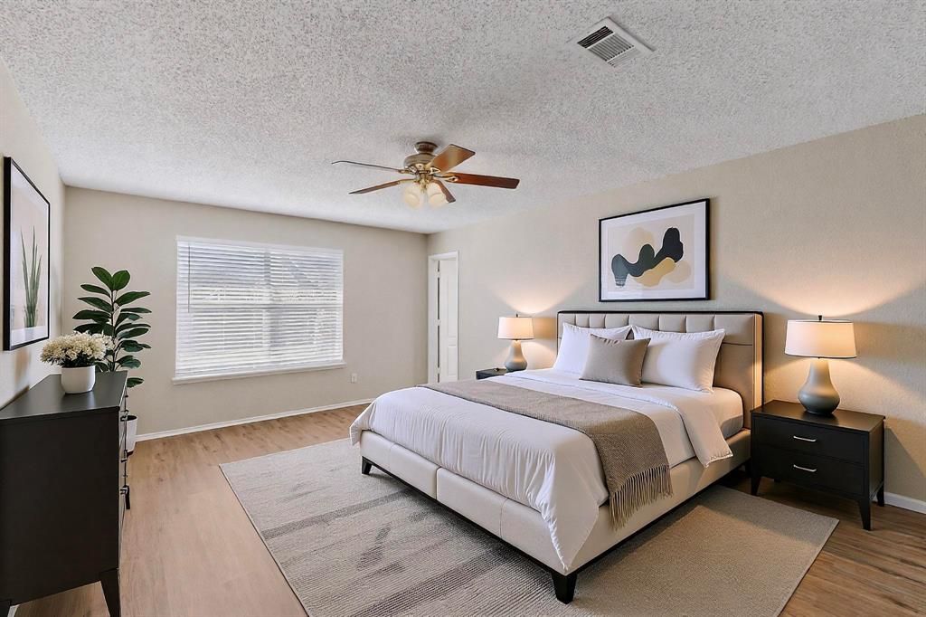 1207 Aberdeen Drive Allen, TX 75002 - Photo 30 of 40 a bedroom with a large bed and a chandelier