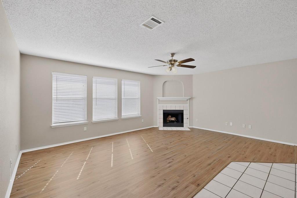1207 Aberdeen Drive Allen, TX 75002 - Photo 6 of 40 a view of an empty room with a fireplace and a window