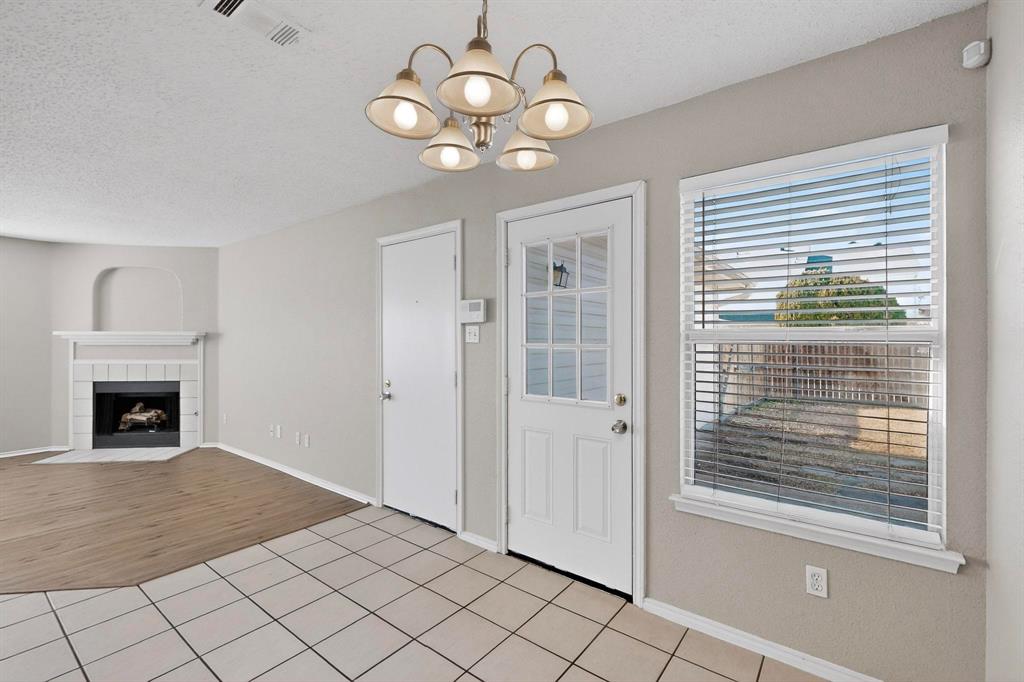 1207 Aberdeen Drive Allen, TX 75002 - Photo 10 of 40 a view of a livingroom with a chandelier fan and fire place