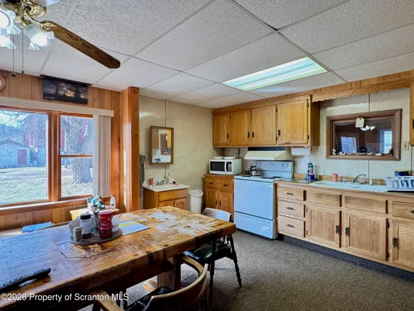a kitchen with a table chairs stove and cabinets