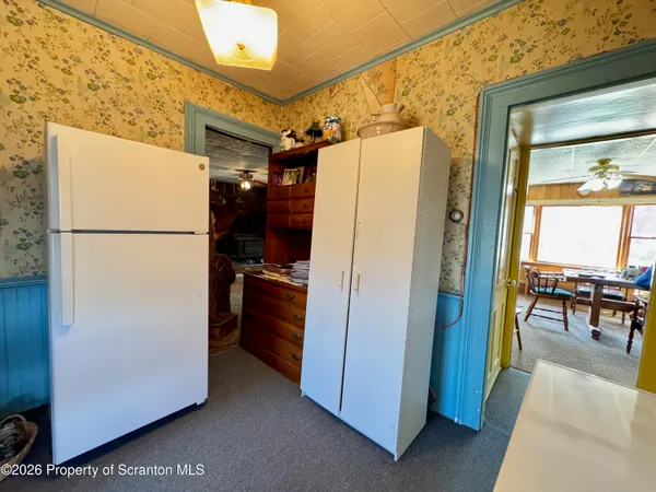 a white refrigerator freezer and a stove sitting inside of a kitchen