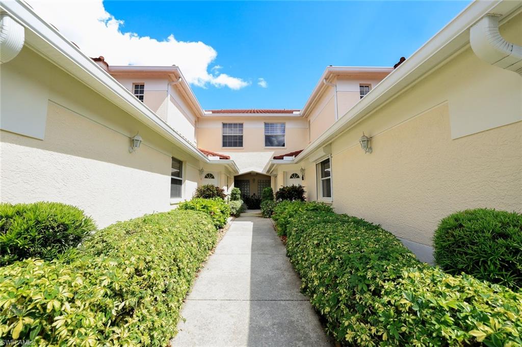 630 Lalique Circle, Unit 506 Naples, FL 34119 - Photo 1 of 25 a view of a back yard with flower plants
