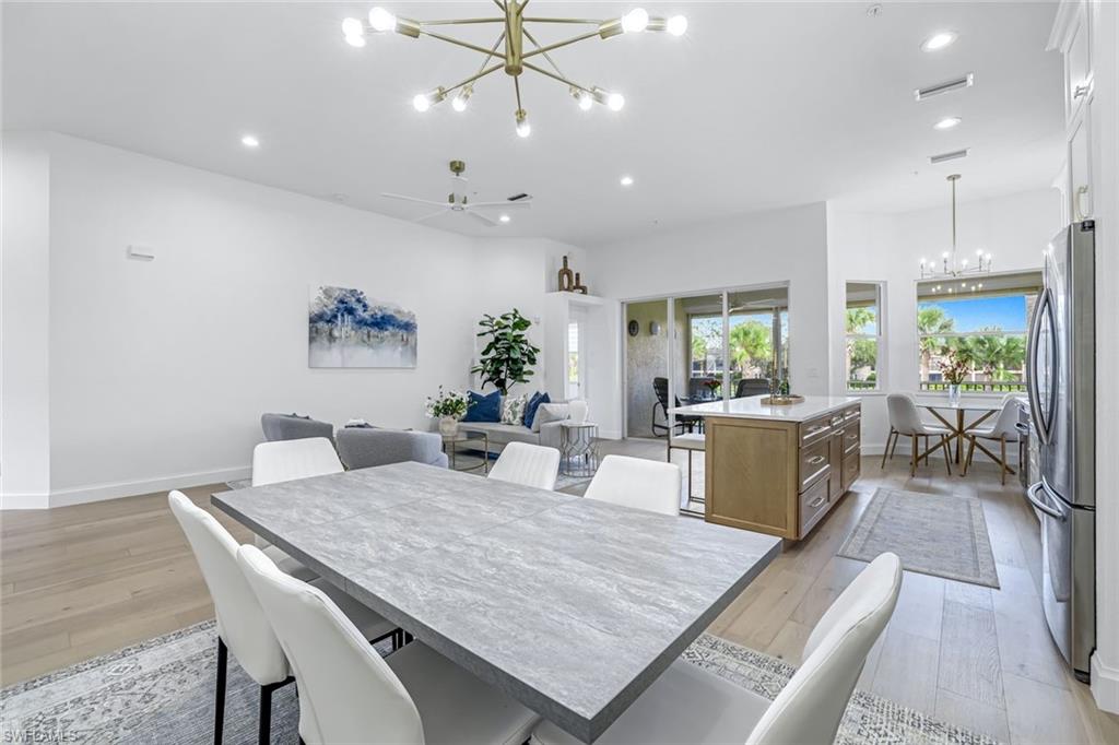630 Lalique Circle, Unit 506 Naples, FL 34119 - Photo 11 of 25 a living room with furniture kitchen view and a chandelier