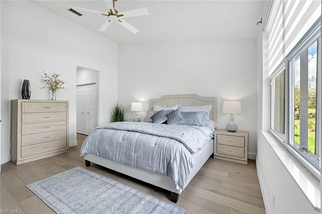 630 Lalique Circle, Unit 506 Naples, FL 34119 - Photo 12 of 25 a bedroom with a bed and a dresser