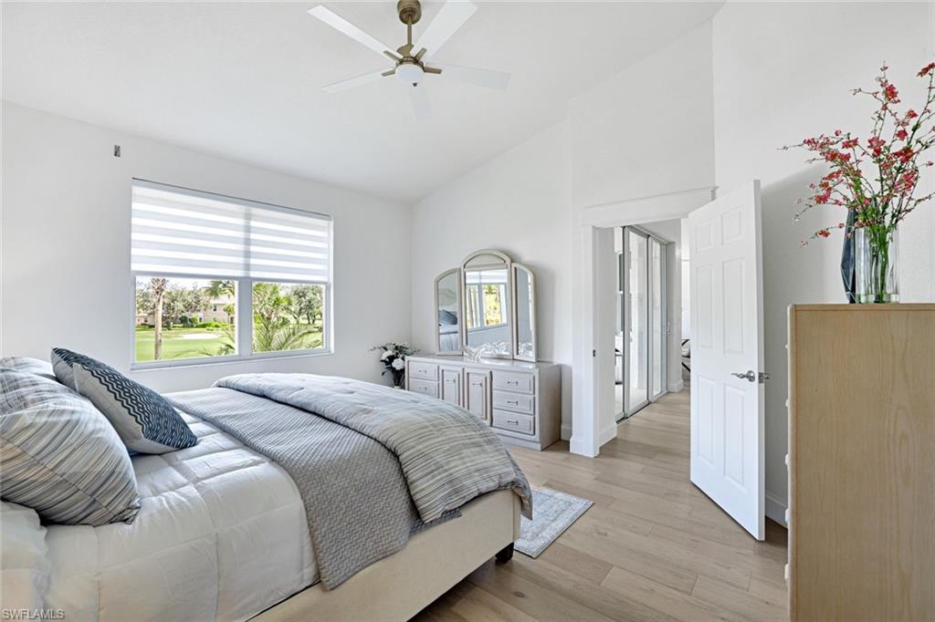 630 Lalique Circle, Unit 506 Naples, FL 34119 - Photo 13 of 25 a bed sitting in a spacious bedroom next to a window
