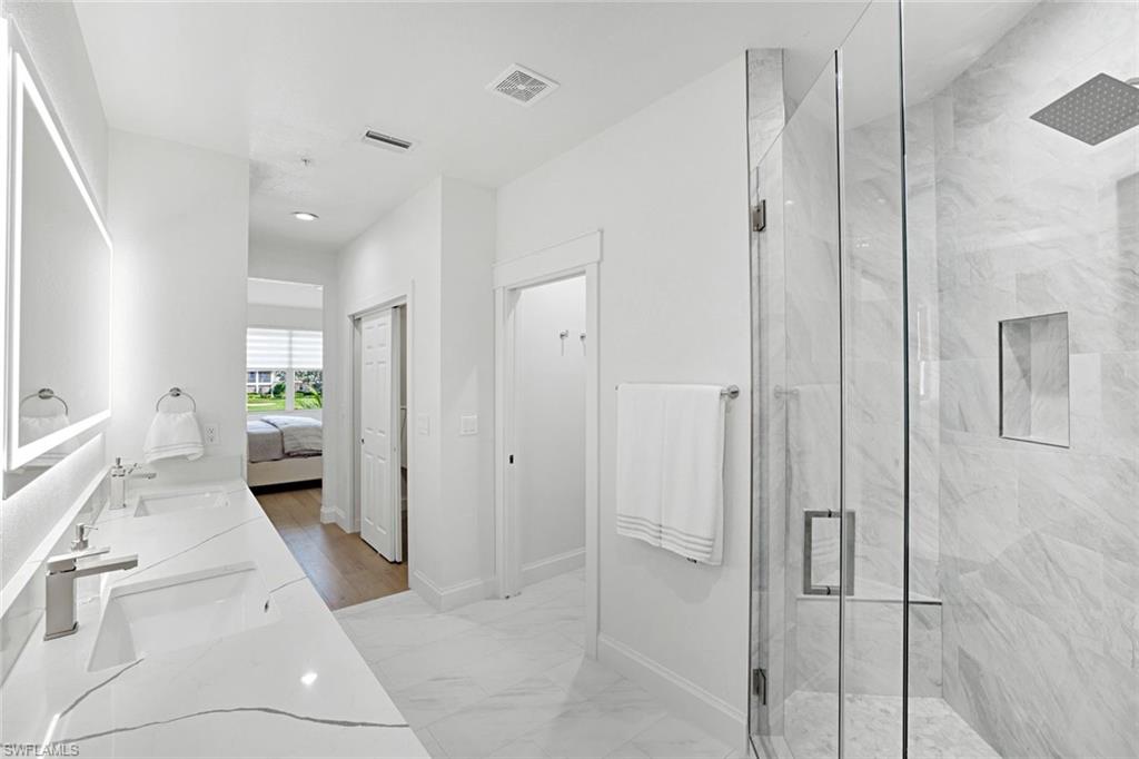 630 Lalique Circle, Unit 506 Naples, FL 34119 - Photo 15 of 25 a en suite bathroom with a shower