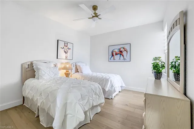 a bedroom with bed and a potted plant