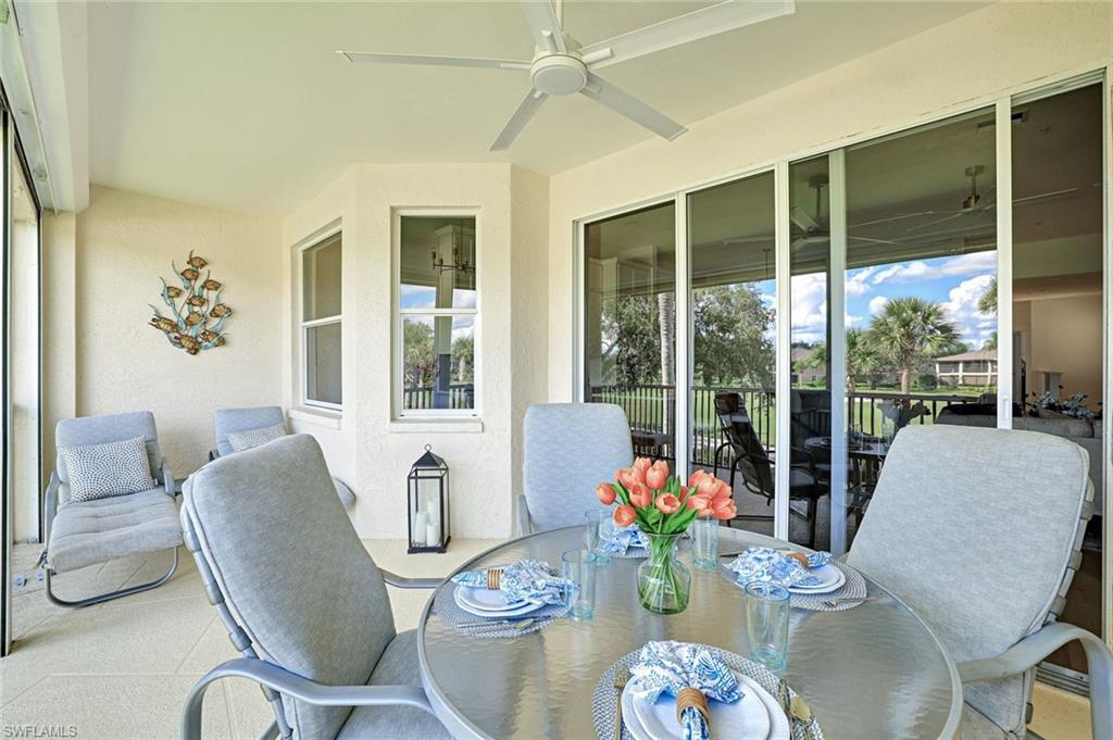 630 Lalique Circle, Unit 506 Naples, FL 34119 - Photo 23 of 25 a living room with furniture and a large window