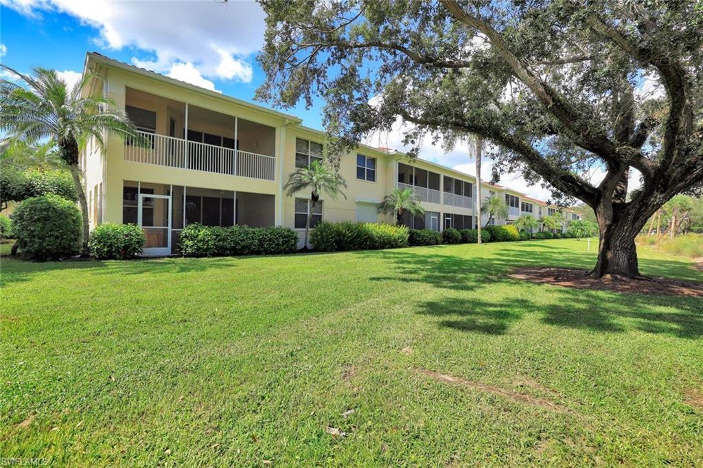 630 Lalique Circle, Unit 506 Naples, FL 34119 - Photo 24 of 25 a front view of house with yard and green space