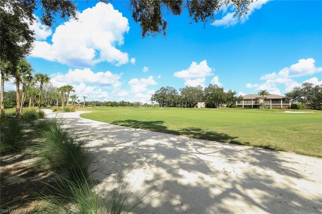 630 Lalique Circle, Unit 506 Naples, FL 34119 - Photo 25 of 25 a view of a golf course with a lake view