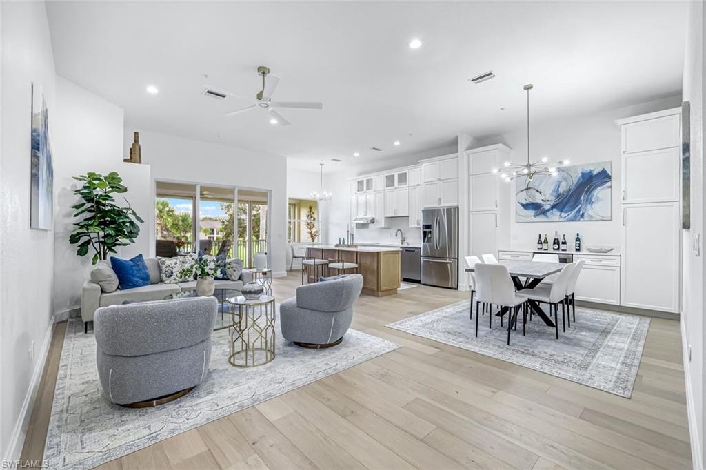 630 Lalique Circle, Unit 506 Naples, FL 34119 - Photo 5 of 25 a living room with furniture kitchen view and a chandelier